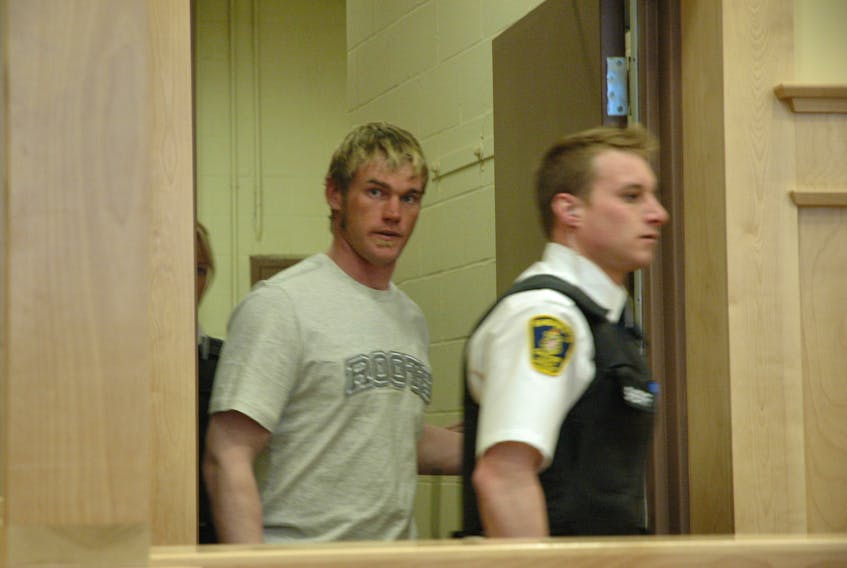 Robert Traverse, originally from Fleur-de-Lys, is led into provincial court in Corner Brook in this undated photo.