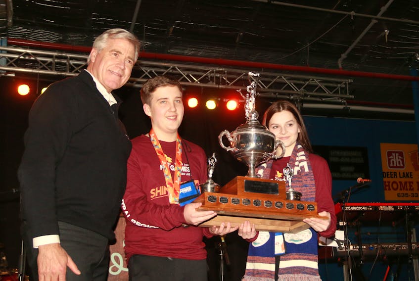 Jenna Lilly, right, of Springdale and Joshua Waterman of Hare Bay accept the Premier’s Cup from Premier Dwight Ball at the closing ceremonies of the Newfoundland and Labrador Winter Games in Deer Lake.