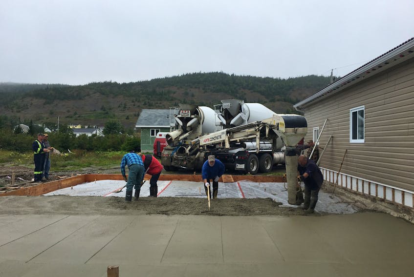 The team hard at work on the fire hall project. Left to right: truck operators from Hunts Concrete, volunteers Embry Oxford and Jamie Oxford, Fire Department member Morris Reid and volunteers Curtis Andrews and Brian Welshman