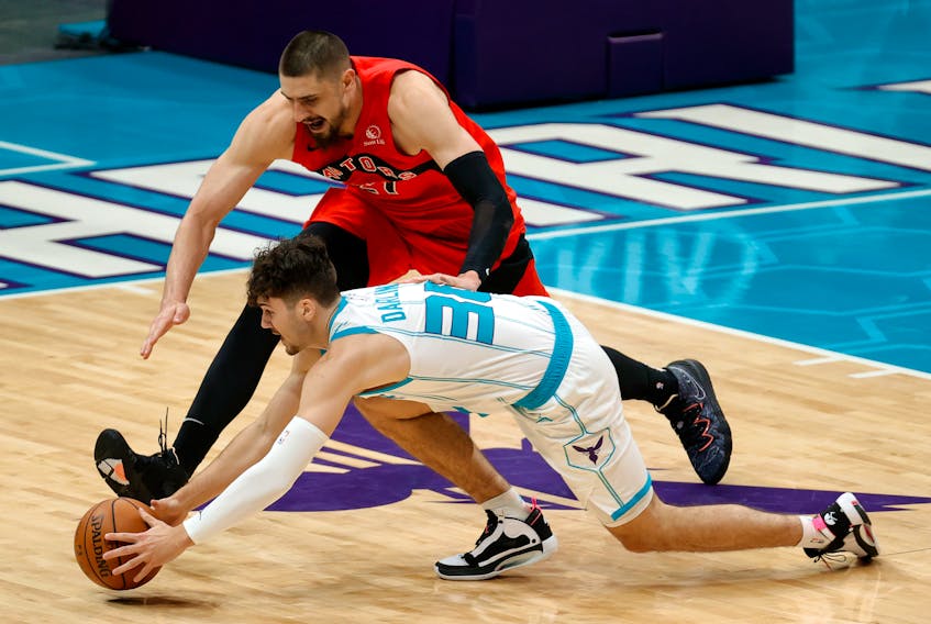 Bedford’s Nate Darling of the Charlotte Hornets  battles for a loose ball against the Toronto Raptors in a pre-season NBA game on Monday. - Jared C. Tilton (NBA Photos/Getty Images)