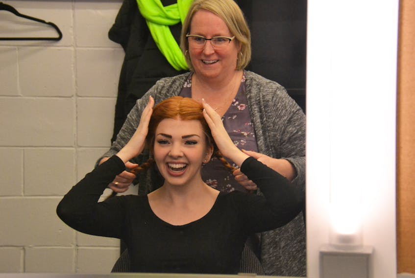 Wig mistress Honey Landry tries red braids on actress Emma Rudy at the Confederation Centre on Thursday morning. Rudy is the 19th actor to play Anne Shirley in “Anne of Green Gables – the Musical”.