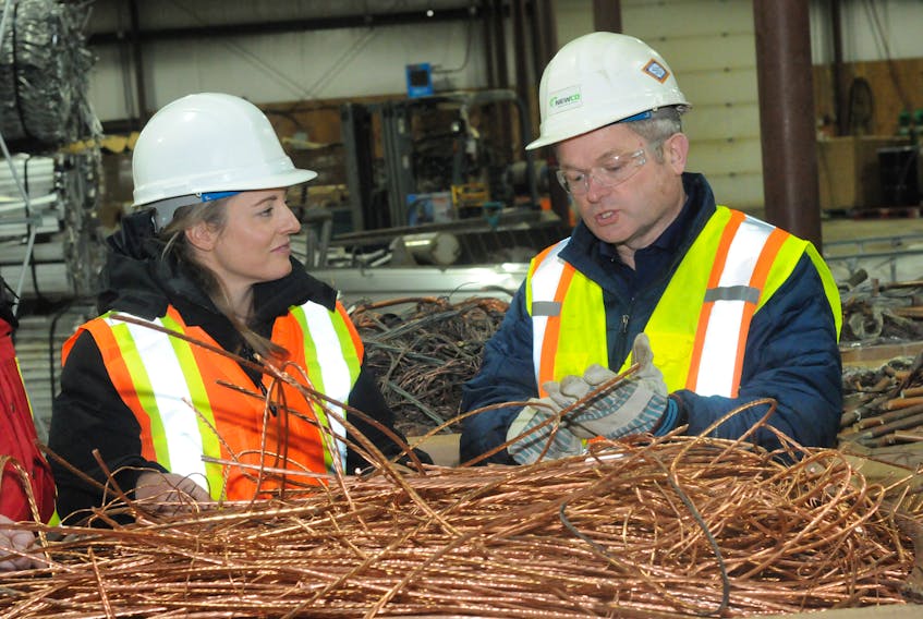 Melanie Joly, federal minister of economic development, and Bob Anstey, president of Newco Metal and Auto Recycling Ltd., at a tour of the company’s facilities in Foxtrap on Thursday. Joe Gibbons/The Telegram