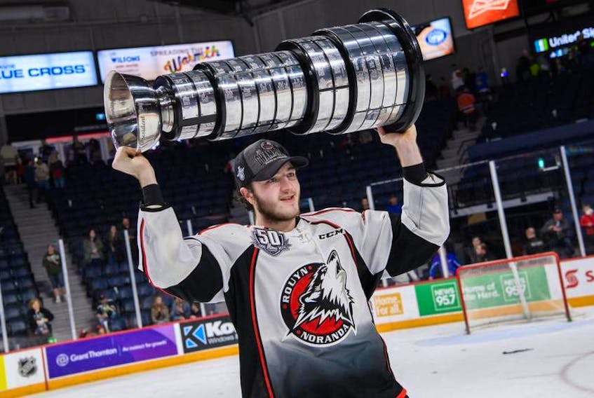 Rouyn-Noranda Huskies defenceman Noah Dobson raises the President Cup on Saturday night at the Scotiabank Centre.