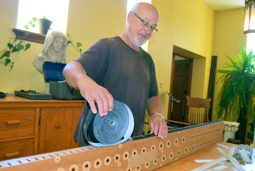 Brian Evers works on the 1962 Casavant organ that is being installed at Saint Ninian Cathedral Parish in Antigonish.