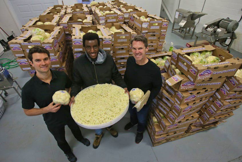 Outcast Foods chief marketing officer TJ Galiardi, employee Gary Chelsea and CEO Darren Burke are seen with trays of cauliflower, otherwise destined for the landfill, which the the company upcycles. Outcast takes the surplus of fruit and vegetables and turn them into high value, long shelf life, whole-plant powders. TIM KROCHAK/ The Chronicle Herald