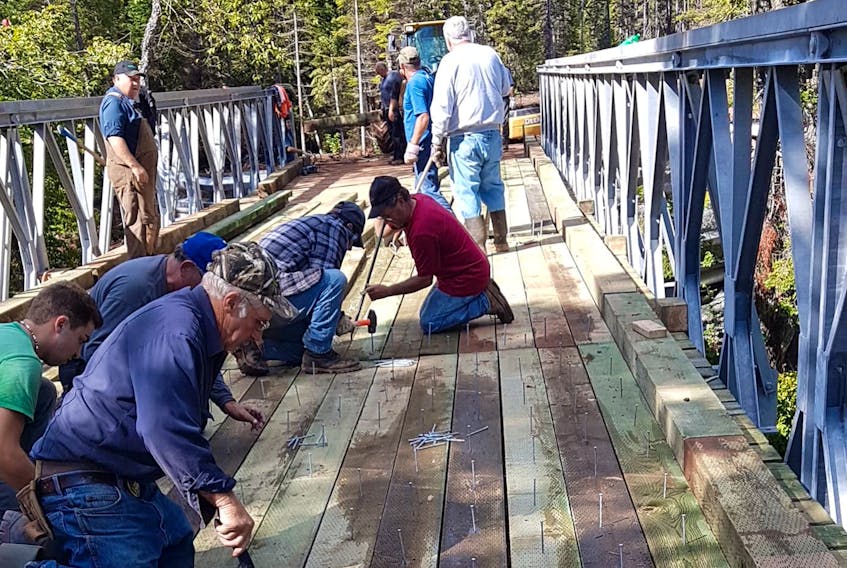 Members of the Oxford and Area Trails Association and other trails groups and ATV and snowmobile enthusiasts came together Sept. 22 to put the decking on a new multi-use bridge over the Black River near Oxford. The project is the third and final phase of a multi-year plan to connect Oxford to the Trans Canada Trail system. - Wade Adshade photo