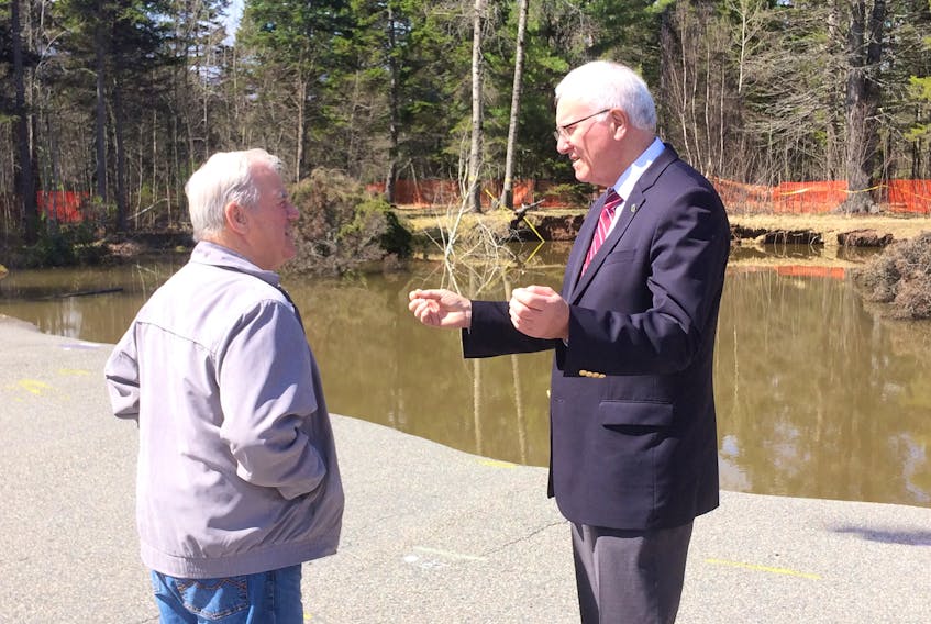 Cumberland-Colchester MP Bill Casey (right) speaks with Oxford Lion Bruce Selkirk after announcing federal funding for geophysical testing of the sinkhole in the Lions Park and surrounding areas.