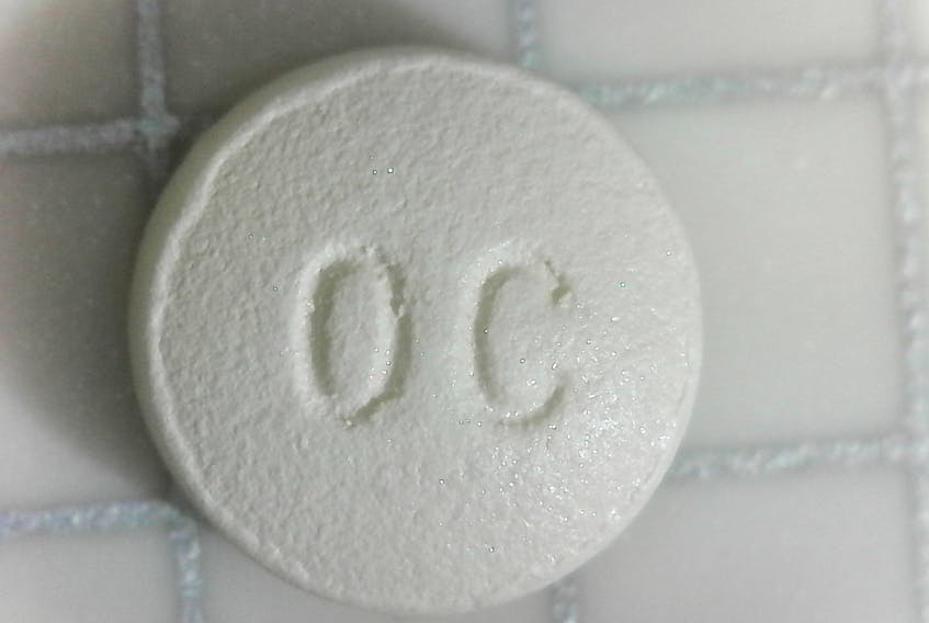 Both sides of a 10-milligram OxyContin pill are shown. - Wikipedia Commons