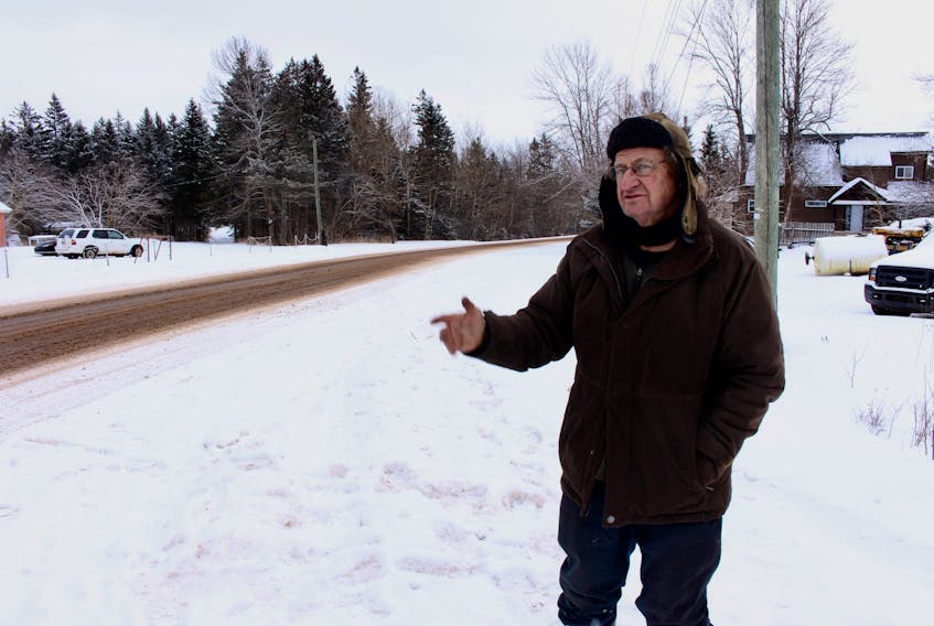 Jim Walmsley points out some of the issues he thinks make a turn dangerous near his home in Bedford-Dunstaffnage. “It’s almost scary standing around here, I find,” he said, as cars sped by. Michael Robar/The Guardian 