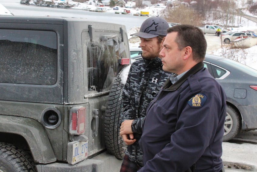 RCMP escort Mitchell Fennell into Clarenville provincial court Jan. 11.