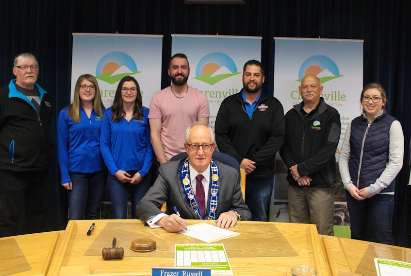 From left to right are Kevin Goodyear, Danielle Baker, Erin Whalen, Nicholas Peach, Brandon Reardon, Rod Nichol, Claire Sawler , as mayor Frazer Russell signs the proclamation declaring June as Recreation Month in Clarenville.