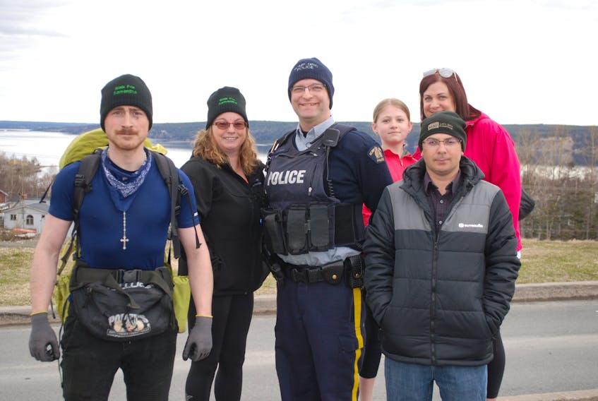 Neil Hamilton is seen with supporters and RCMP escort ahead of a community walk last week.