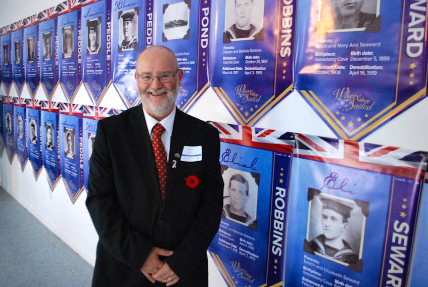 Lester Green of the Southwest Arm Historical Society with the banners of the 87 Royal Navy veterans from the First World War. For more photos from the event in Little Heart’s Ease and Hodge’s Cove on Nov. 8, go to www.thepacket.ca.