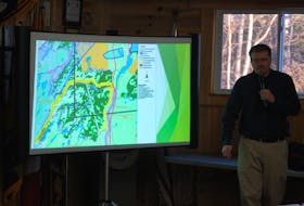Port Blandford Mayor Chad Holloway shows a map of the proposed cutting and explains how rezoning the area will block clearcutting in the region.