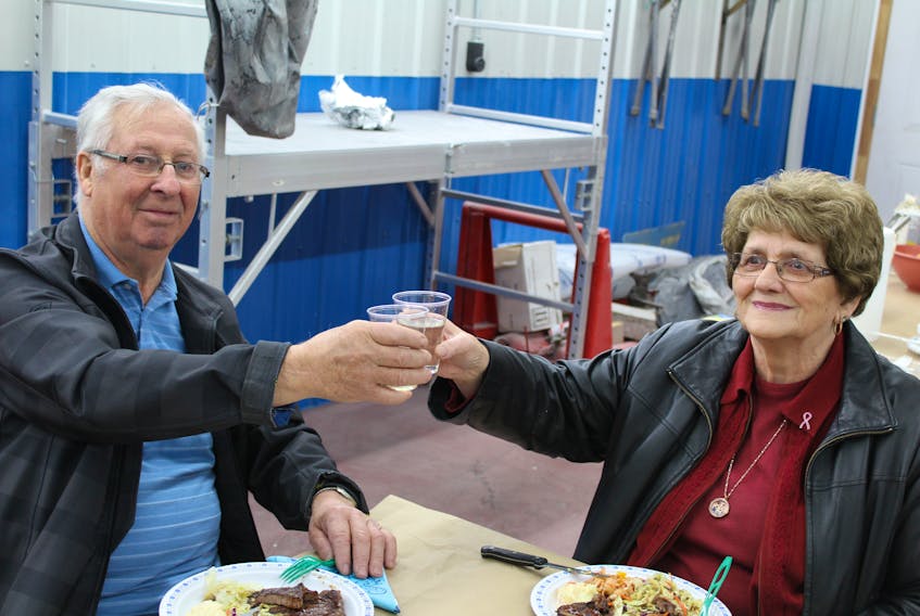 John and Joan Baker toast to retirement after 48 years as owners of Baker's Autobody in Milton.