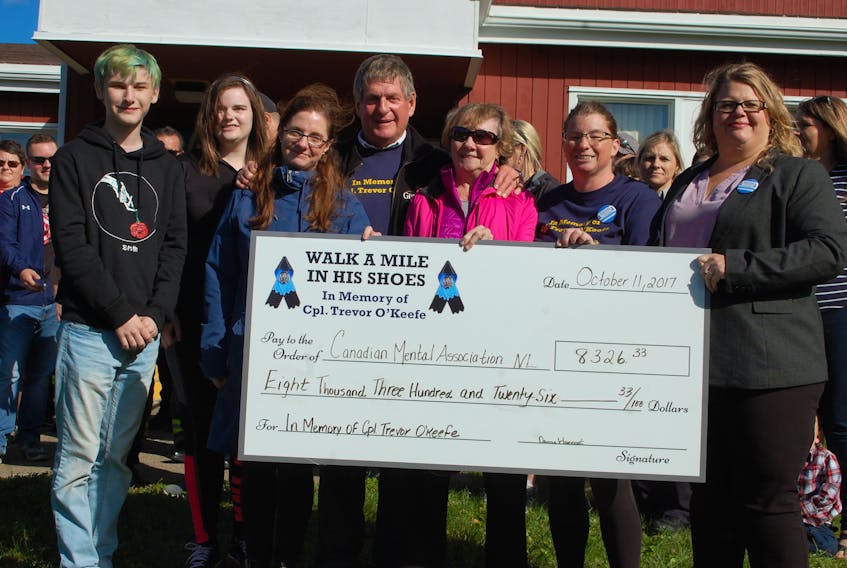 Donna Hancock and the O’Keefe family at last year’s walk presenting the cheque of funds raised to the Canadian Mental Health Association.