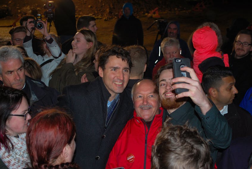 Trudeau and Churence Rogers taking selfies with those in attendance at the Bill Davis Chalet in Clarenville.