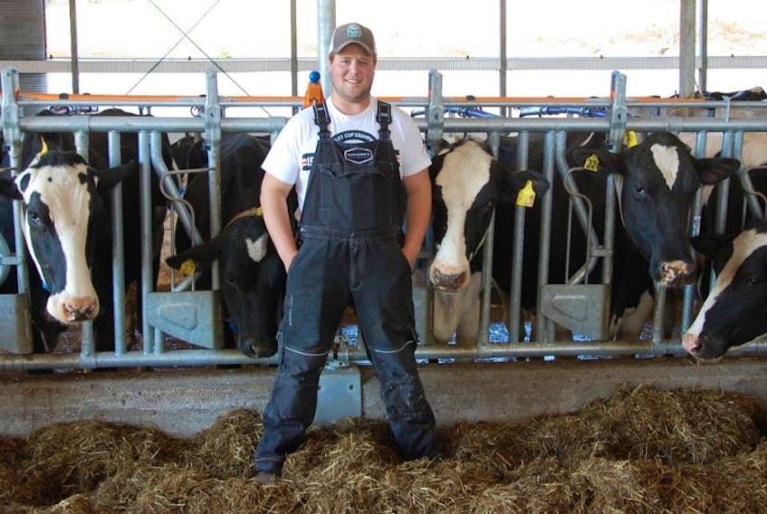 Luke Strong poses with some of his cows.  There's about 100 more elsewhere on the farm.
