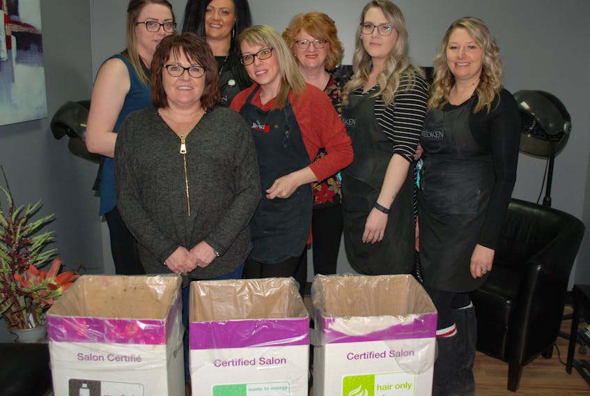 The staff of Headz Up Hair Studio with their recycling receptacles. Left to right are: Vanessa Strong, Diane Adams-Hagerman, Vanessa Mills, Anastasia Slade, Shirley Barrington, Cassondra Cooper and Renee Smith.