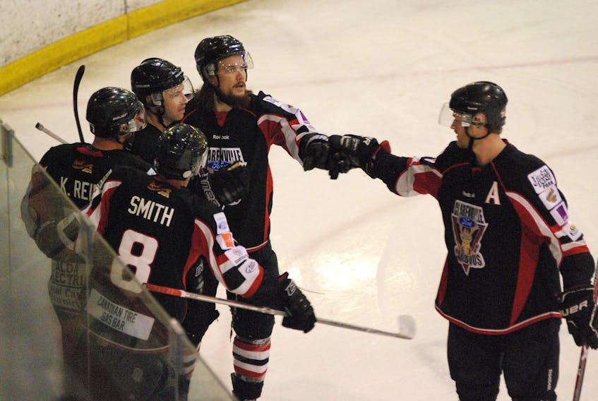 Fist bump! Andrew Smith, Kevin and Mason Reid, Chad Earle, and Brandon Roach celebrate the Caribous' go-ahead-goal Saturday night at Clarenville's home opener.