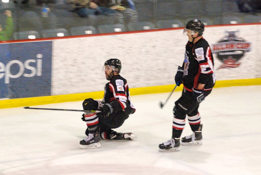 Ryan and Keith Delaney celebrate after Ryan scored shorthanded to tie the game in the second period.