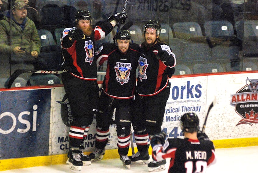The Clarenville Ford Caribous (left to right: Justin Pender, Kevin Reid and Chad Earle) celebrate a goal during CWSHL play last season.
