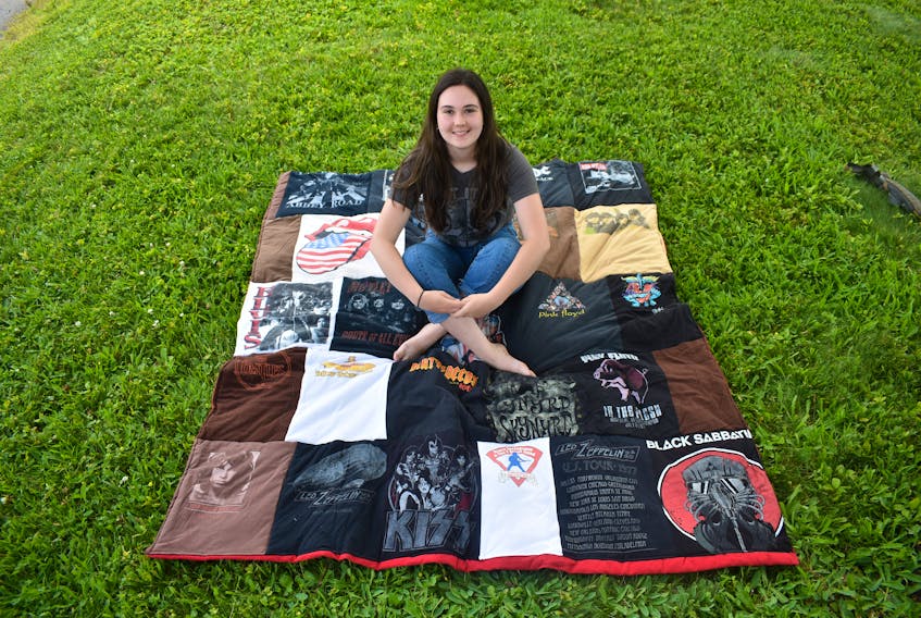 Jillian Martin and her classic rock-themed quilt she made out of old t-shirts.