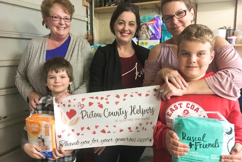 Pictou County Helpers aim to give help when it is needed, whether it is a mother in need of diapers, a dad who can’t stretch his budget to include school snacks or a senior who comes up short. Three of the group’s members are, from left, Lynn Arsenault, Jillian Gellately and Andrea Fuller, with junior helpers Patrick Gellately and Austin Tate.