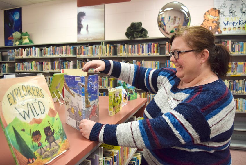 Cheryl McInnis, a library clerk at the New Glasgow branch, straightens out some book in the children’s section.