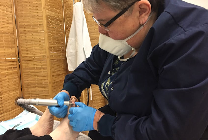 Lynn McCara goes to work on an ingrown toenail with an electric filer at Max Your Step Foot Care by Nurses.