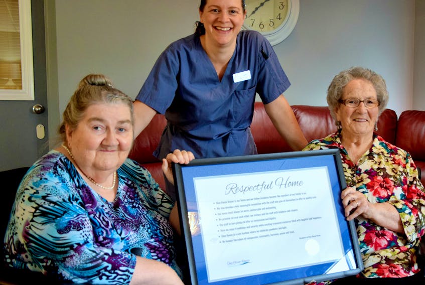 Linda Mayo, President, Glen Haven Manor Resident Council (left) and fellow resident Lillian Ross proudly show Haley MacDonald, CCA (centre) the newly framed Respectful Home Statement which was approved by the Glen Haven Manor Resident Council. Beautifully famed copies complete with the Glen Haven seal are on display in all resident care areas throughout the nursing home.