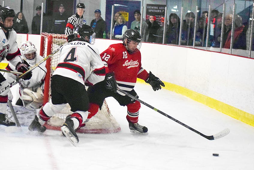 Pictou County Scotians forward Grant Fraser battles for the puck at the side of the Cole Harbour Colts net on Oct. 6.