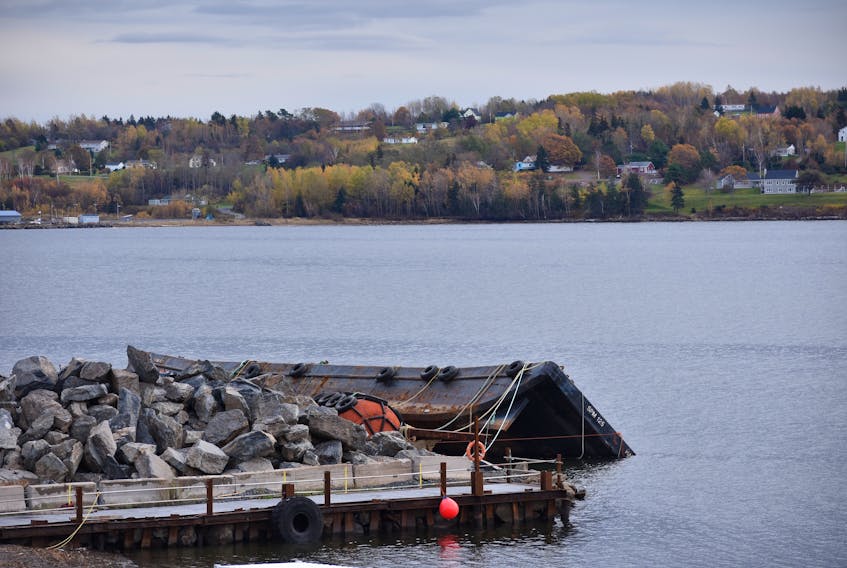 Barge turned over in the water outside Pictou Shipyard.