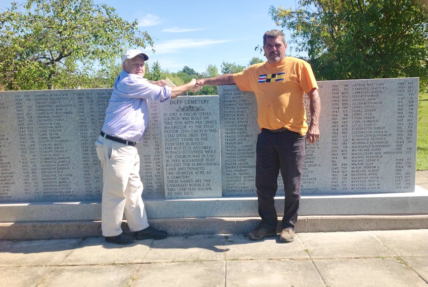 On Sept. 6, Philip MacKenzie (left) thanked Rob Harvey (right) of Heritage Memorials Limited of Windsor, Nova Scotia for completing the cleaning and relettering of the memorial at the front entrance of the Duff Pioneer Cemetery, New Glasgow.