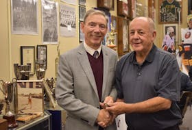 Barry Trenholm (right) hands over the keys to the Pictou County Sport Heritage Hall of Fame to its new curator, Michael Malcolm, on Dec. 5, 2019.