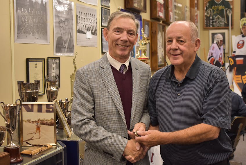 Barry Trenholm (right) hands over the keys to the Pictou County Sport Heritage Hall of Fame to its new curator, Michael Malcolm, on Dec. 5, 2019.