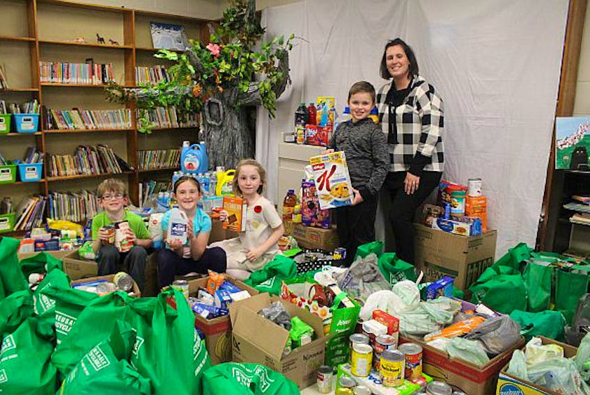 Students at Trenton Elementary held a food drive during the month of October. Shown in the picture with 2,036 pounds of food are from left, students Benjamine Jardine, Quinn McCarron, Avery MacDonald, Nate Wilson, and teacher Danielle McCarron.