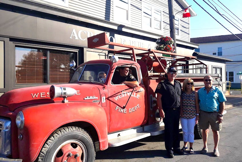 Bill Chace is seated in the old/new fire truck, while Westville Fire Department chief Ken Dunn stands with Andrew and Rhonda Cougias, owners of the Acropole Pizza and Pub.
