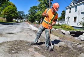Weeks Construction employee Gordon Malcom does some cleanup work on Jubilee Avenue in Stellarton on Aug. 14.