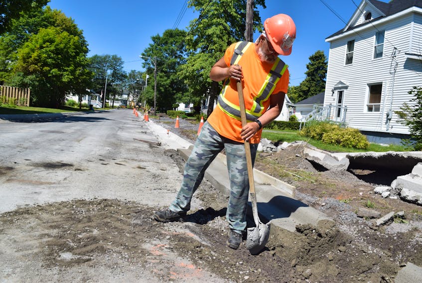 Weeks Construction employee Gordon Malcom does some cleanup work on Jubilee Avenue in Stellarton on Aug. 14.