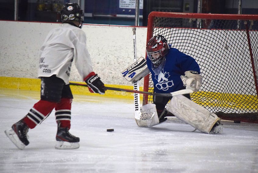 Daniel Chisholm makes a save during a breakaway drill with the PCMHA’s Novice Advanced (Red) team, at a practice at Trenton rink on Jan. 14.