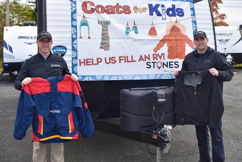 Stone’s RV general manager Greg Park, left, and sales manager Shaun McKeough stand beside an RV they hope to fill with coats for people in Pictou County this winter.