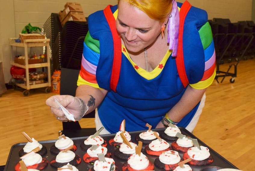 Amanda Verge, decorates some cupcakes at the Call of the Moon Festival in Stellarton.