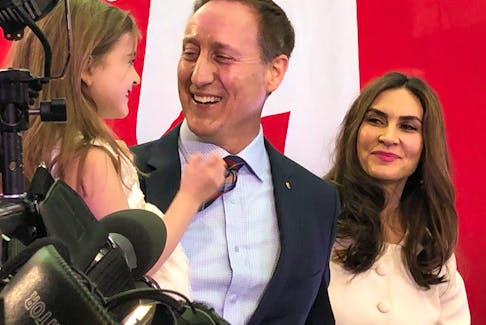 Peter MacKay, his wife Nazanin and one of their children after he officially announced his intention to run for the federal Conservative leadership.
