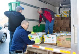 Kinsmen unload a truck of groceries that they purchased to help families in need in Pictou County. From left are Tony Saunders, Tony Hessian and Michael Corkum.