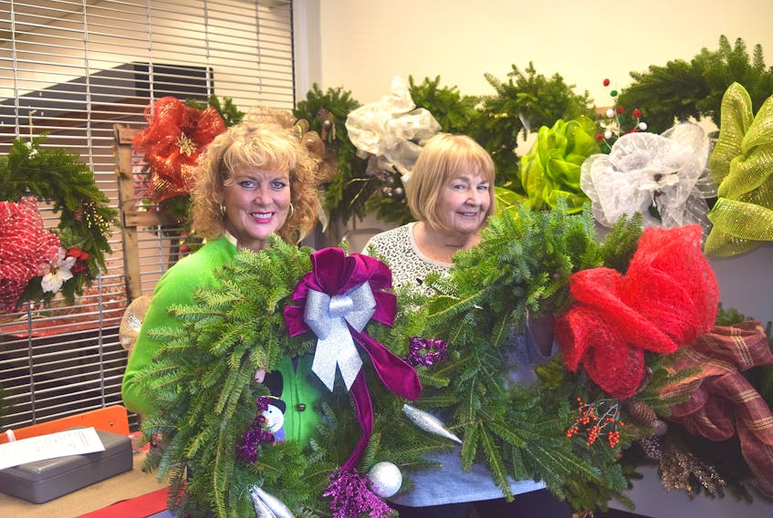 Beth Clarke, left, and Sharon Macdonald with a couple of their hand-made wreaths. These wreaths and others will be offered for sale, with funds raised going to the Aberdeen Hospital auxiliary.