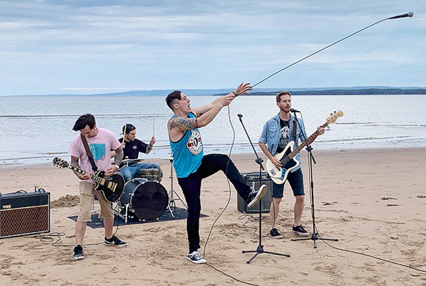 Bigger Brighter Lights are shown at Melmerby Beach during a video shoot last summer. From left are: Brandon Richardson, Anto Pellrine, Nate Fleming and Steve Hamm.