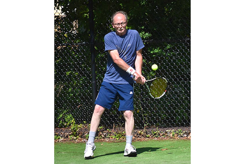 Steve Swift takes aim at a backhand during a rally session at the west side tennis courts in New Glasgow.