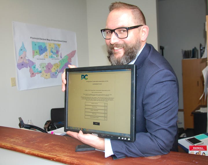 Michael Drake, spokesman for the P.E.I. Progressive Conservative leadership convention committee, poses with the ranked ballot system that has been used over the past week to determine the PC party’s new leader to be declared today