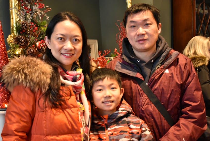 From left, Teresa Zhang, her son Harris Miao and husband Miles Miao pose for a photo on New Year’s Day at their first ever levee. Starting at Government House, the family had plans to head to levees at City Hall, Confederation Centre and wherever the rest of the day takes them. Michael Robar/The Guardian